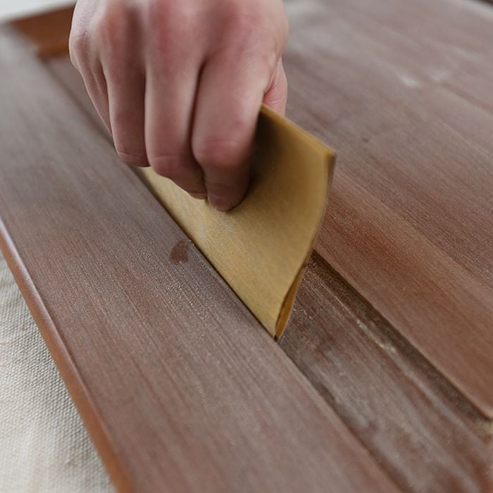 Sanding hard-to-reach areas by folding up a piece of sandpaper into a small square