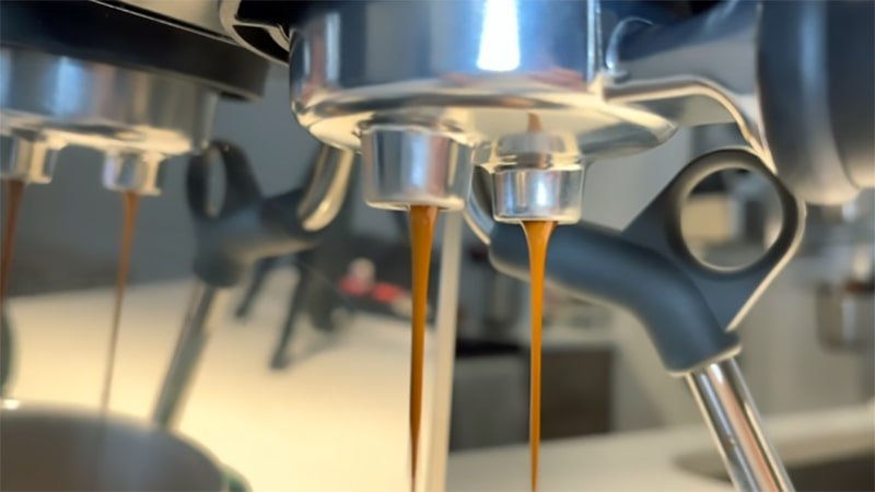The espresso flows from the Breville Bambino