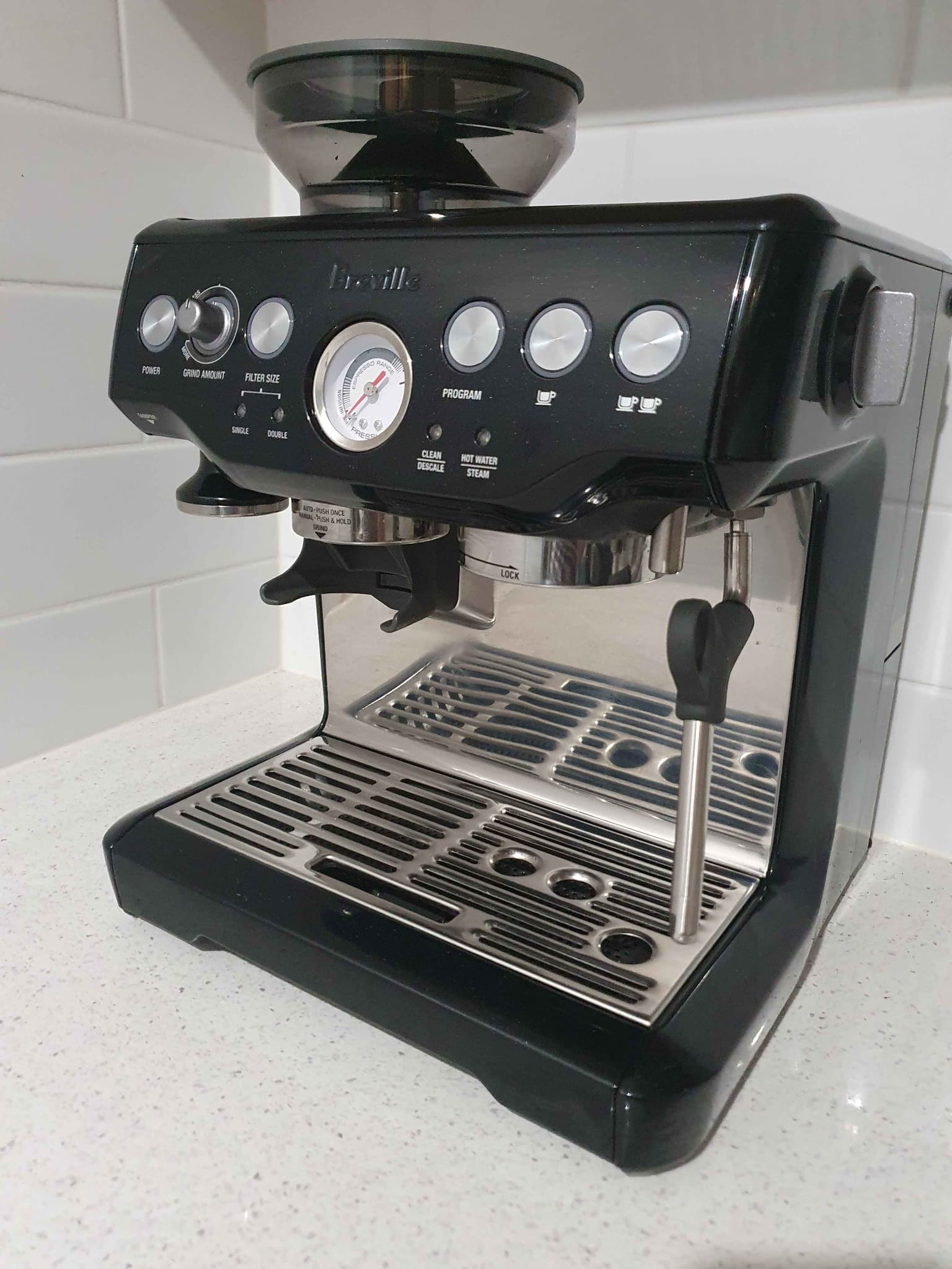 Breville Barista Express has indicators for cleaning and hot water steam